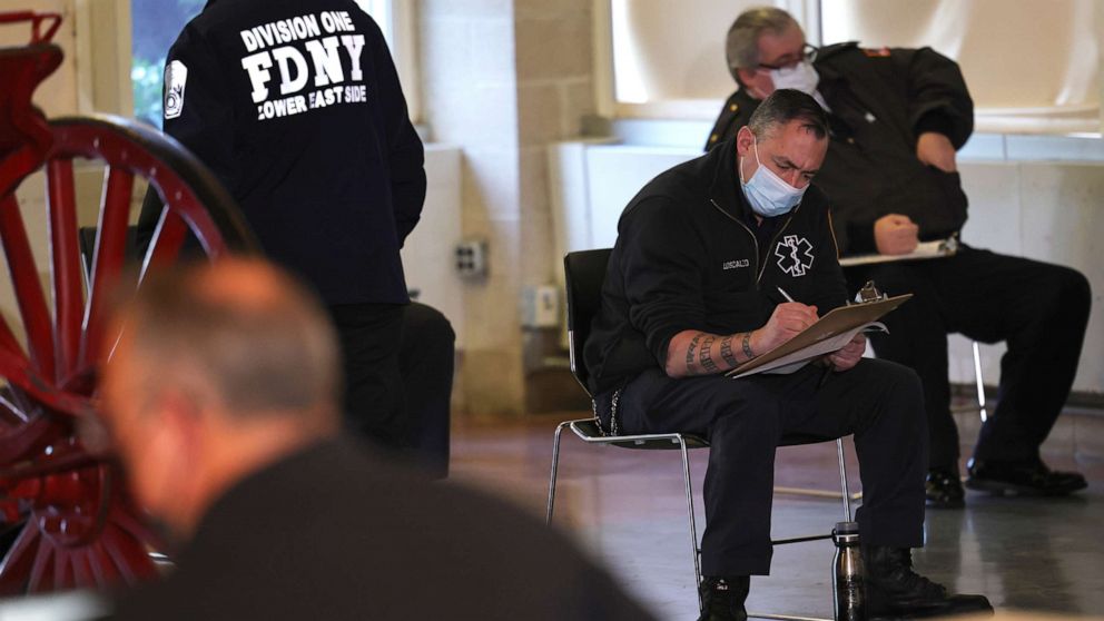 PHOTO: Members of the Fire Department of New York Emergency Medical Services fill out forms as they prepare to receive their coronavirus vaccine on Dec. 23, 2020, in New York.