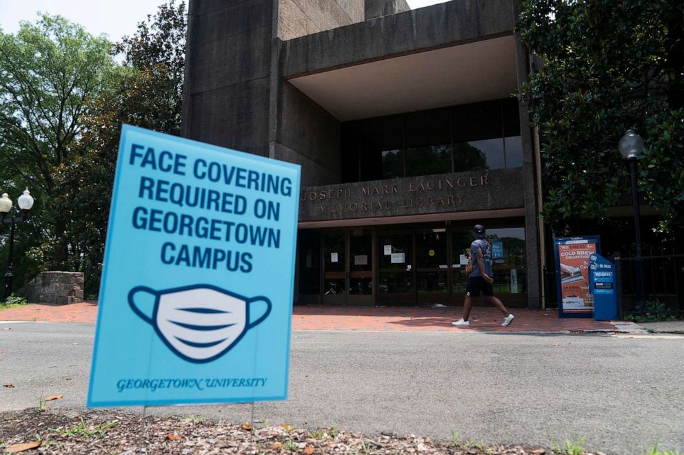 PHOTO: A sign reminding people to wear face masks sits in front of a library on Georgetown University's main campus in Washington, D.C., July 7, 2020.