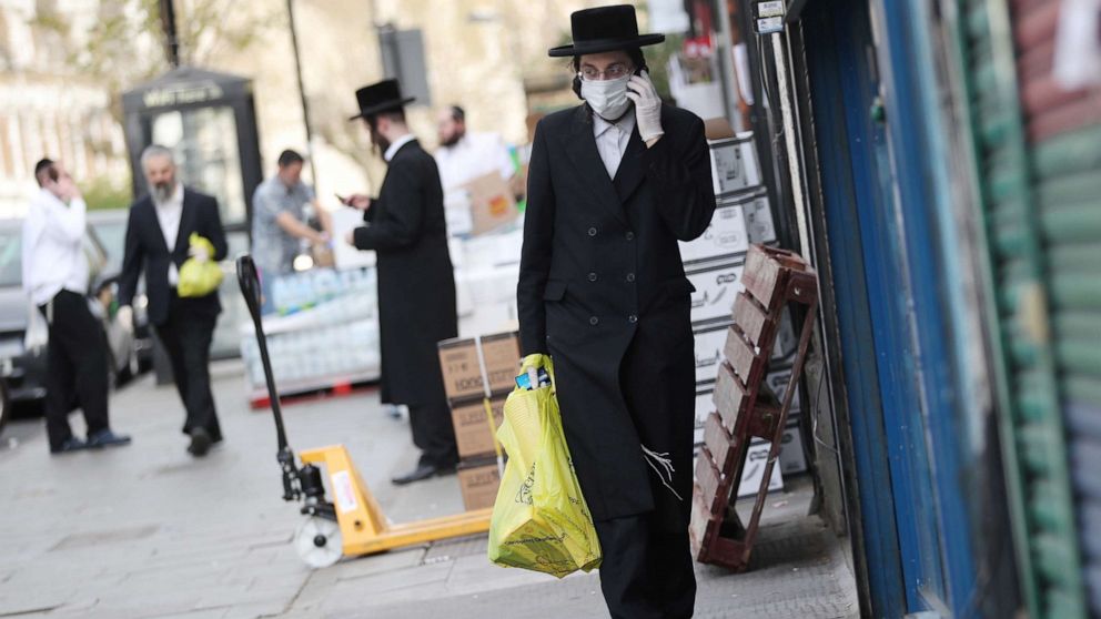PHOTO: An Orthodox Jewish man wearing a protective face mask and gloves is seen in the Stamford Hill neighborhood of London as the spread of the coronavirus disease continues, April 8, 2020.