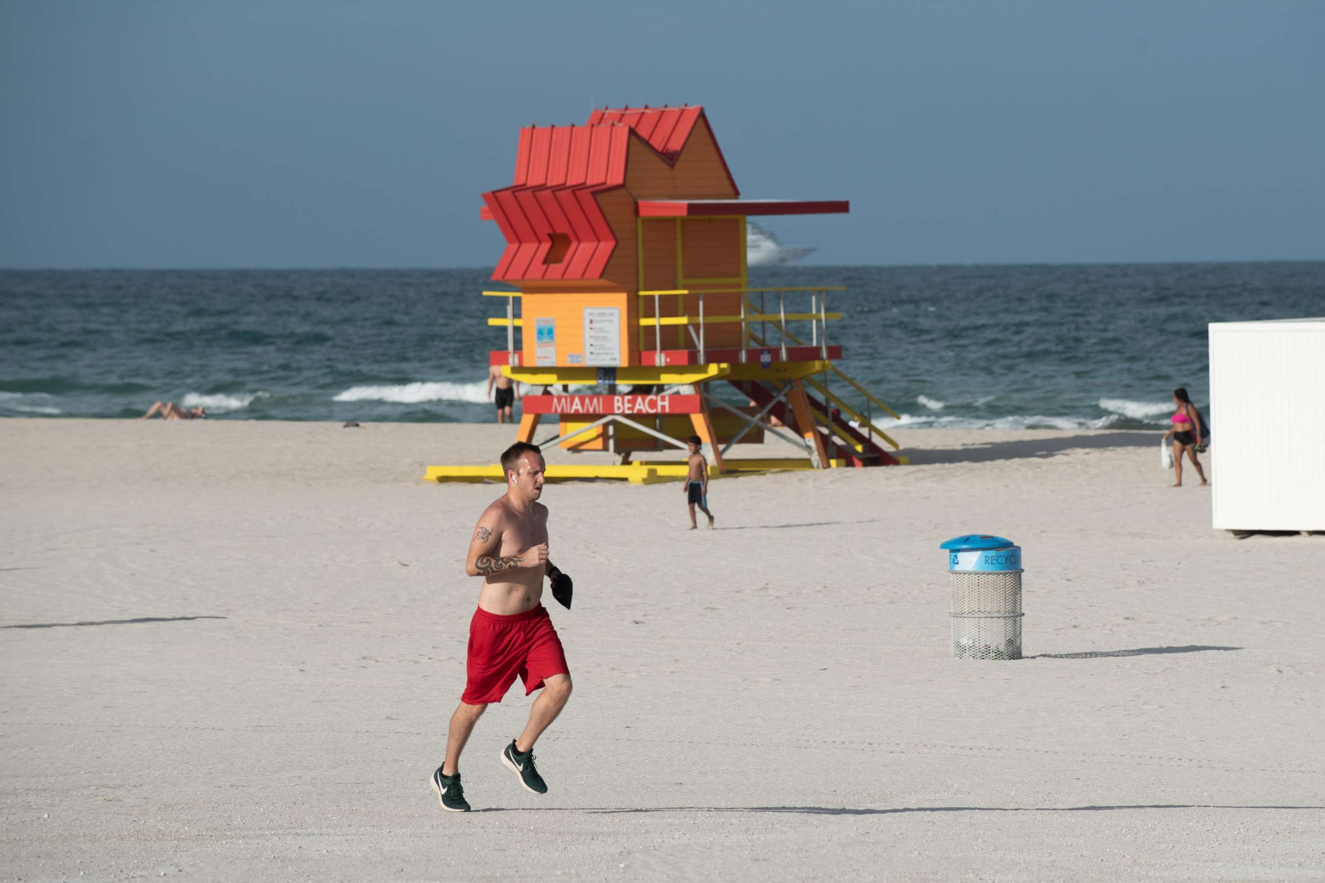 PHOTO: A man runs past a lifeguard stand in Miami Beach, Fla., July 20, 2020.