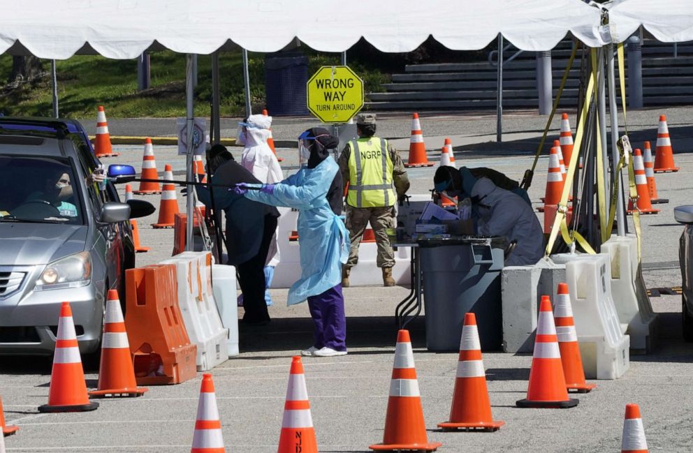 PHOTO: People line up in their cars at the drive-thru COVID-19 testing site at the  Bergen Community College main campus, in Paramus, N.J., May 12, 2020.