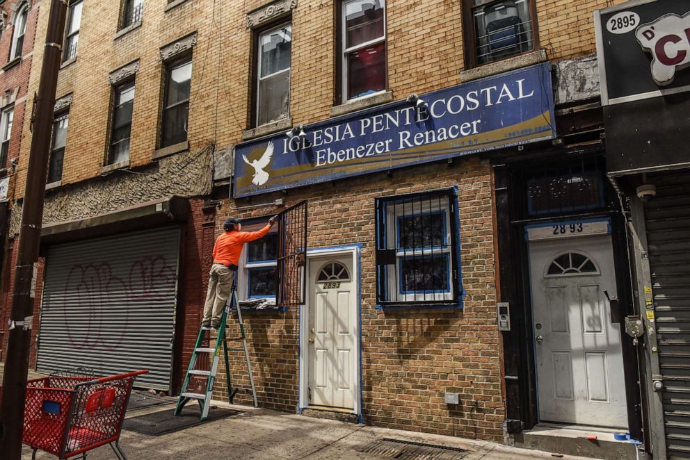 PHOTO: A person paints the outside of a church on May 19, 2020, in the Brooklyn borough in New York.