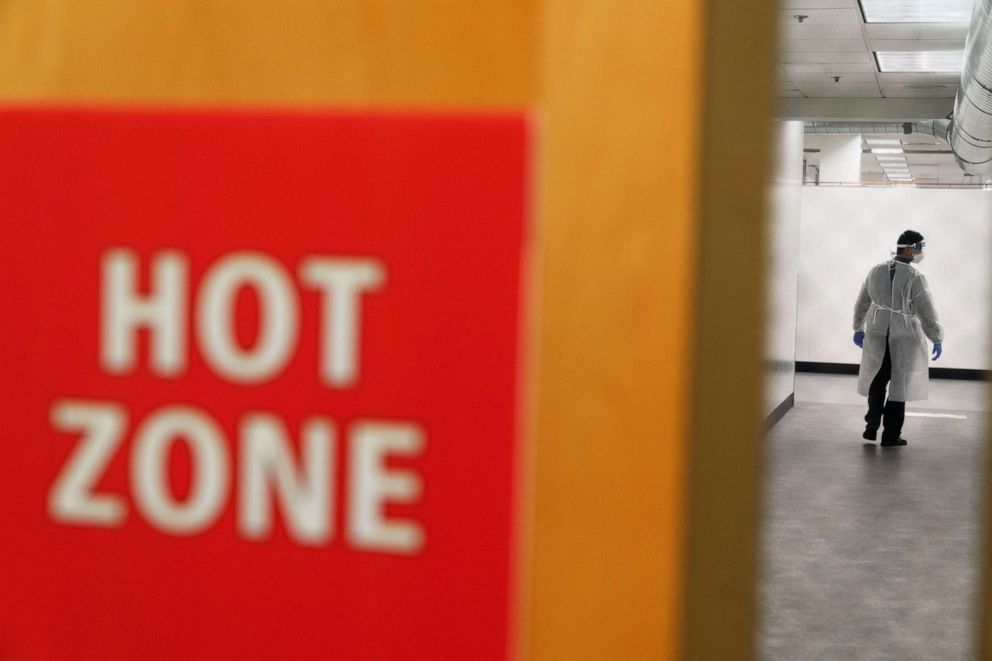 PHOTO: A worker walks through the hallway of a newly opened field hospital operated by Care New England to handle a surge of COVID-19 patients in Cranston, R.I,  Dec. 1, 2020.