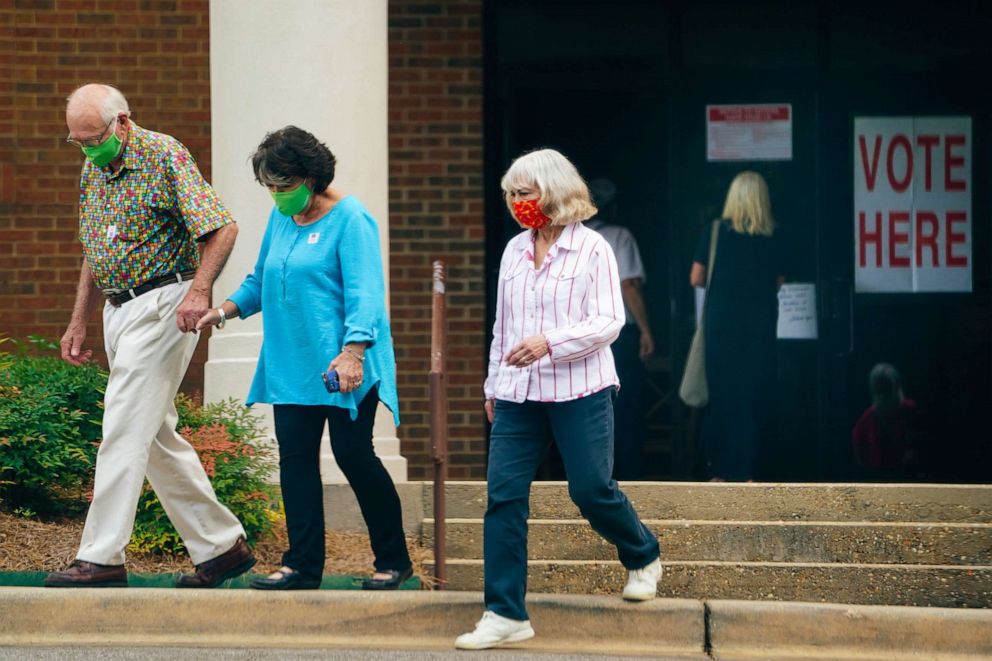PHOTO: Voters wearing protective masks leave a polling location in Montgomery, Ala., July 14, 2020.