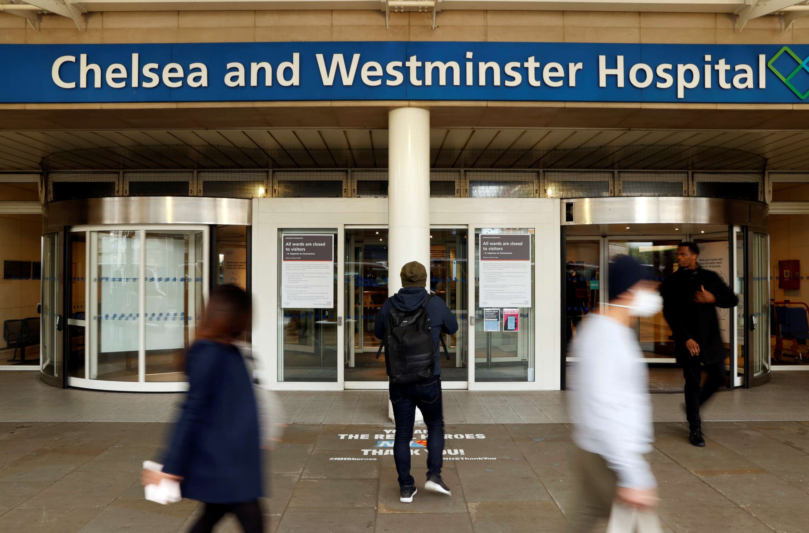 PHOTO: People walk past an entrance to the Chelsea and Westminster Hospital during the outbreak of the coronavirus disease, London, April 29, 2020.