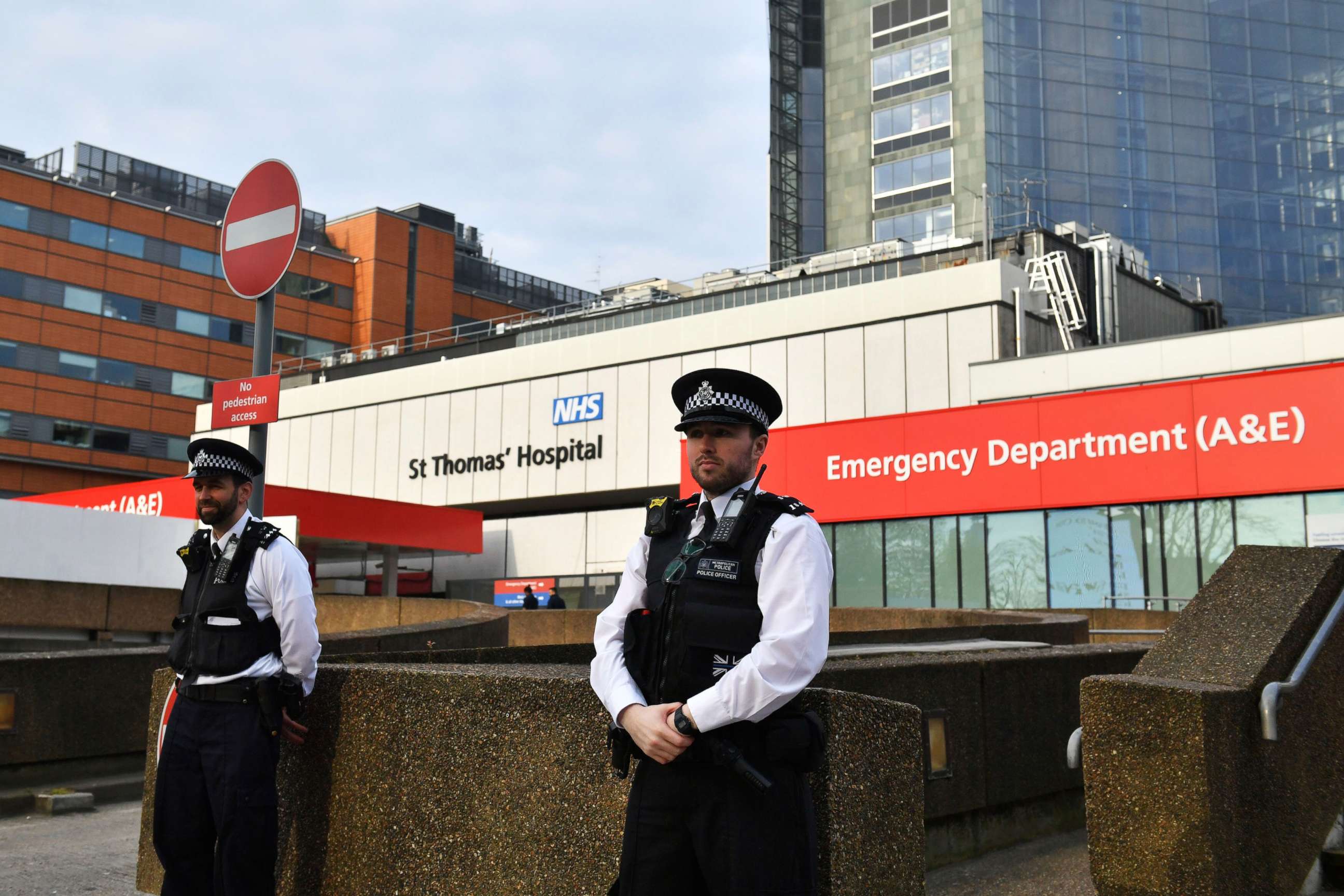 PHOTO: Police officers stand outside St Thomas' Hospital in the background in central London, where Prime Minister Boris Johnson remains in intensive care as his coronavirus symptoms persist, April 8, 2020.