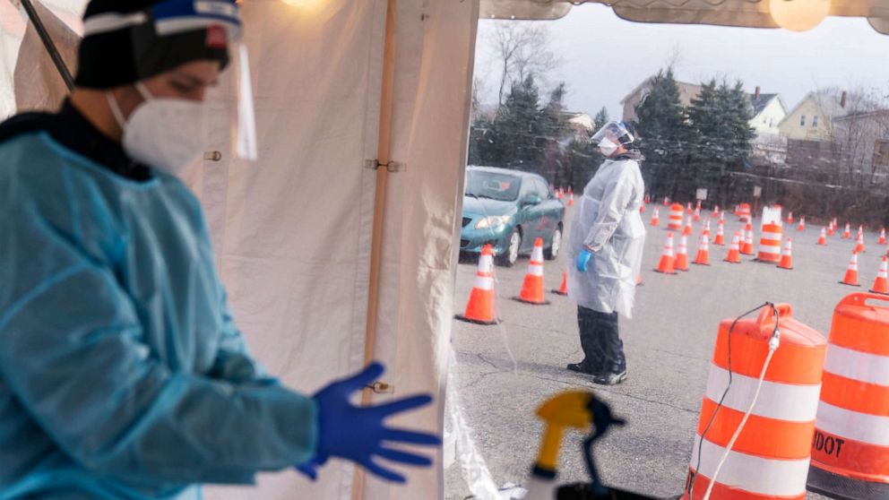 PHOTO: Swabbers prepare to test motorists for COVID-19 at a testing site outside McCoy Stadium in Pawtucket, R.I, Dec. 9, 2020.