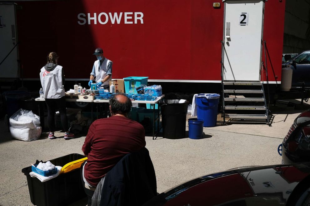 PHOTO: A homeless man waits for a shower to open at a Doctors Without Borders temporary shower trailer in Manhattan for the homeless and other vulnerable communities on May 07, 2020 in New York.