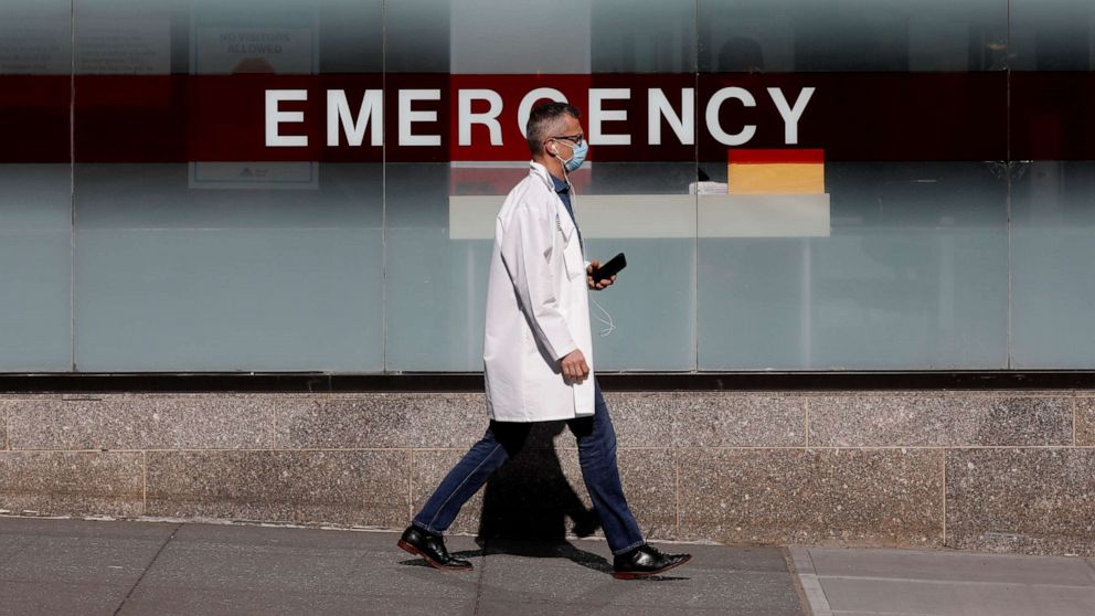 PHOTO: A doctor wears a protective mask as he walks outside Mount Sinai Hospital in Manhattan during the outbreak of the coronavirus disease in New York, April 1, 2020.