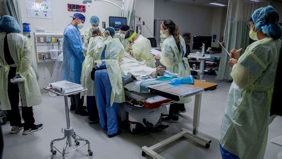 PHOTO: Medical workers help a patient in the emergency room at Riverside University Health System in Moreno Valley, Calif., June 26, 2020.