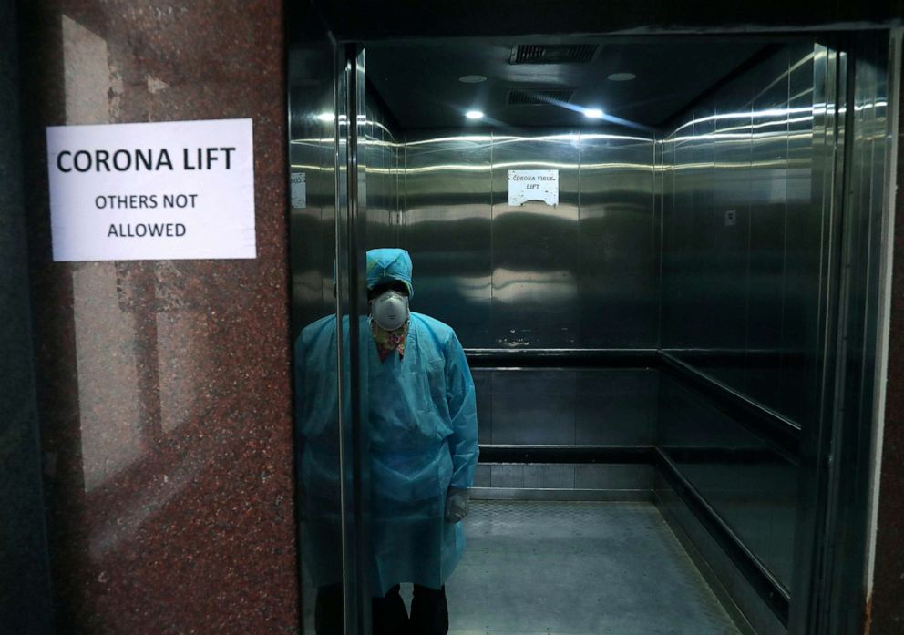 PHOTO: A lift operator stands inside a dedicated lift for people suspected to be infected with the new coronavirus at the Government Gandhi Hospital in Hyderabad, India, March 2, 2020. 