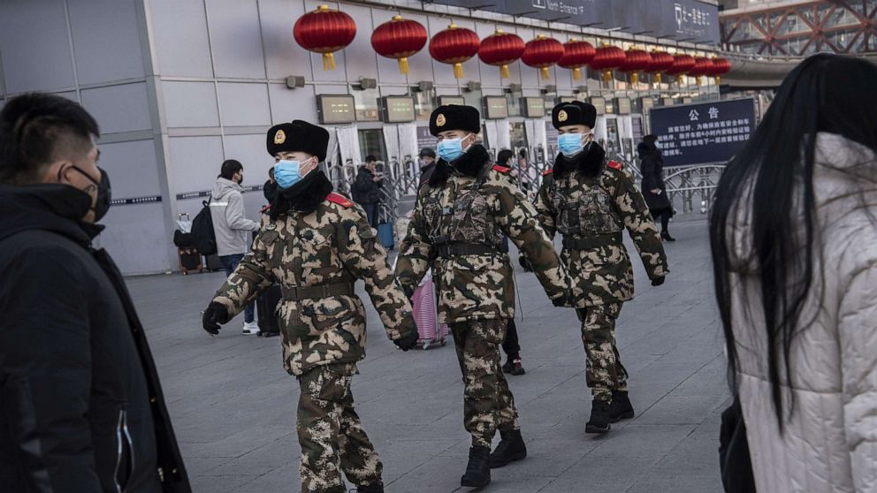 PHOTO: Chinese police officers wear protective masks as they patrol before the annual Spring Festival at a Beijing railway station, Jan. 23, 2020, in Beijing, China. 