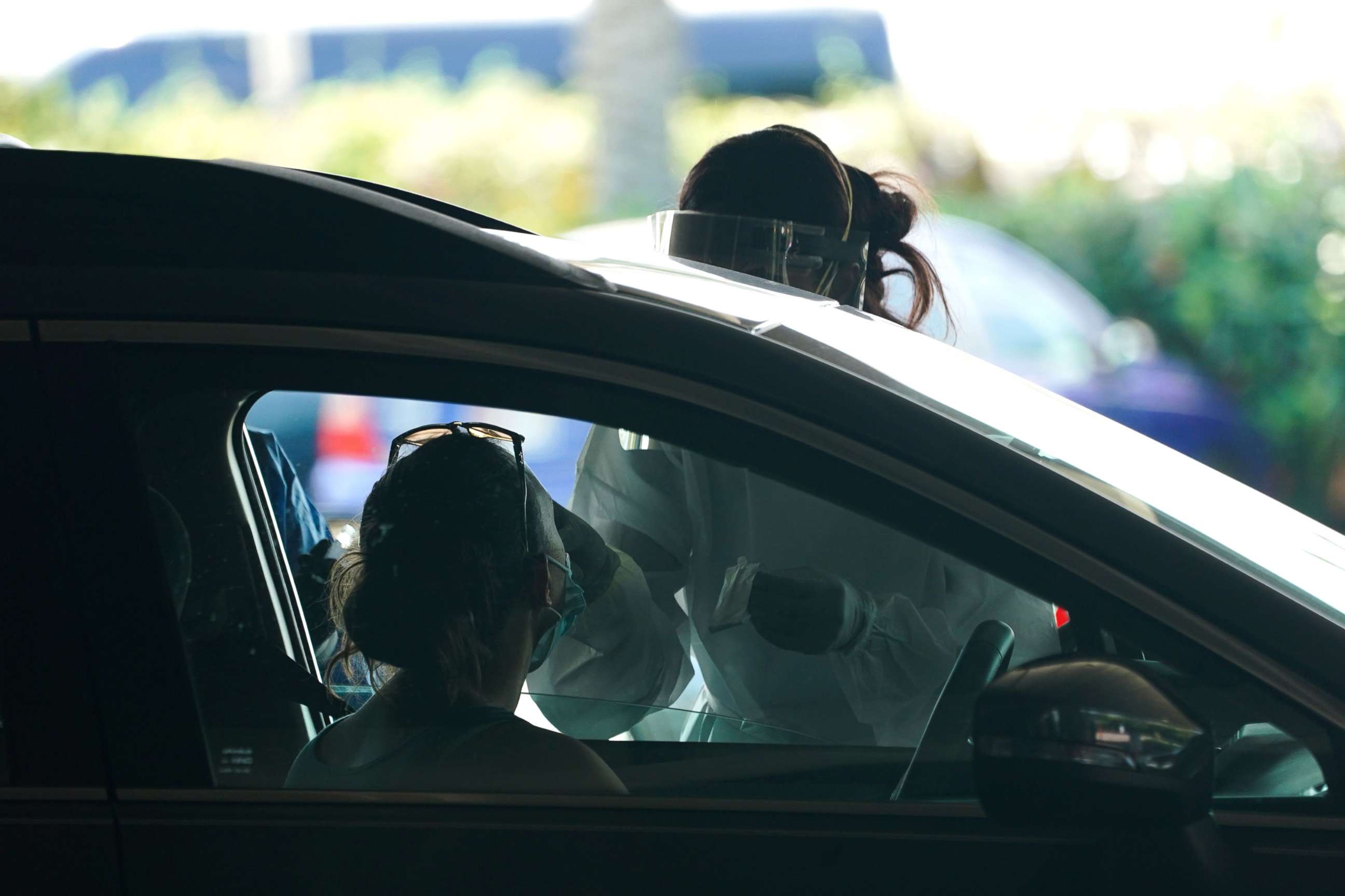 PHOTO: A medical workers takes a swab from a drive at a drive-thru COVID-19 testing site at the Mahaffey Theater, July 24, 2020, in St. Petersburg, Fla.