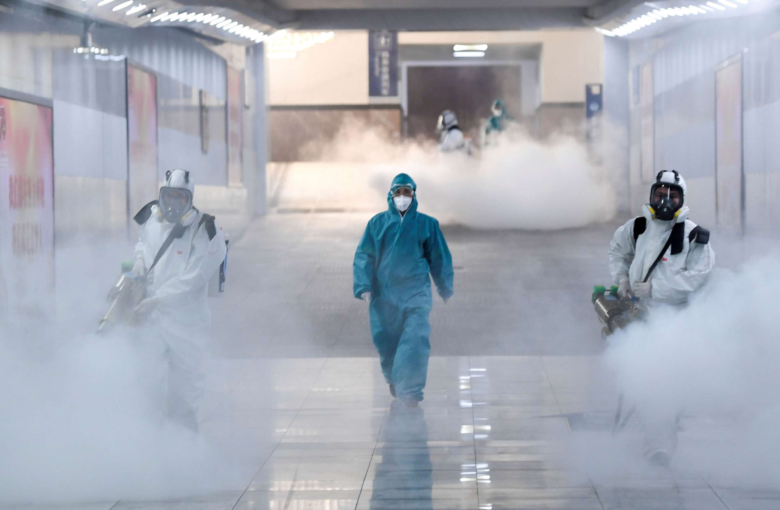 PHOTO: Volunteers in protective suits disinfect a railway station as the country is hit by an outbreak of the new coronavirus, in Changsha, Hunan province, China, Feb. 4, 2020.