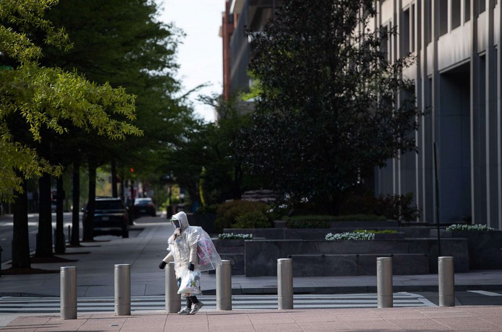PHOTO: A person wearing a mask is seen outside the headquarters of the International Monetary Fund as the IMF and World Bank hold their Spring Meetings virtually due to the outbreak of COVID-19, in Washington, April 15, 2020.