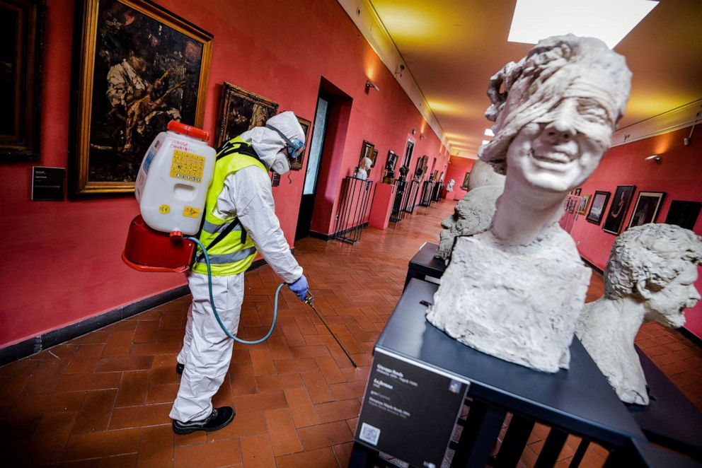 PHOTO: A worker sprays disinfectant to sanitize against coronavirus in a museum in Naples, Italy, March 10, 2020. 