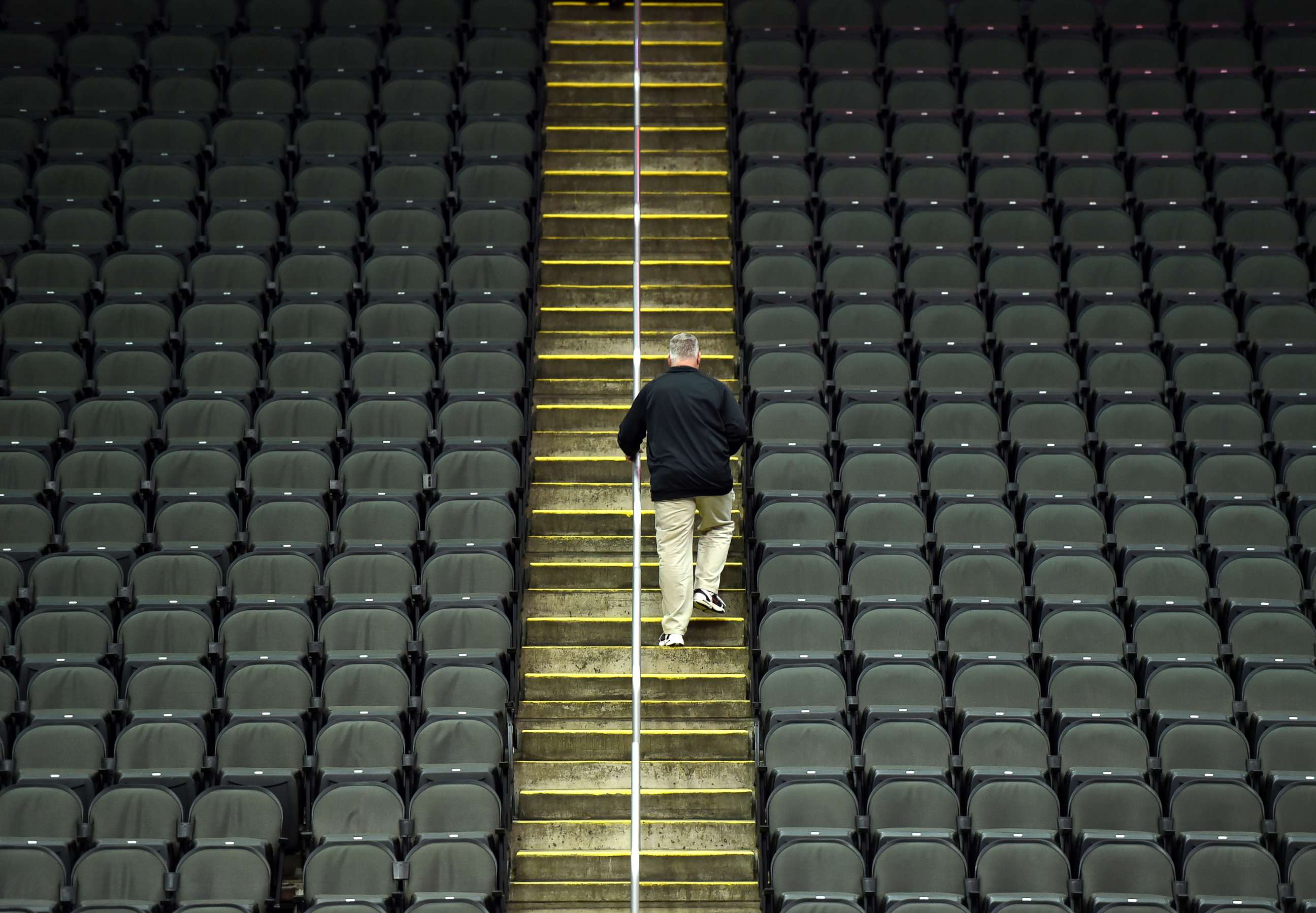 PHOTO: A lone fan exits Sprint Center after it was announced that the Big 12 basketball tournament had been cancelled due to growing concerns with the Coronavirus outbreak on March 12, 2020, in Kansas City, Mo.