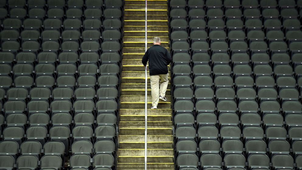 PHOTO: A lone fan exits Sprint Center after it was announced that the Big 12 basketball tournament had been cancelled due to growing concerns with the Coronavirus outbreak on March 12, 2020, in Kansas City, Mo.