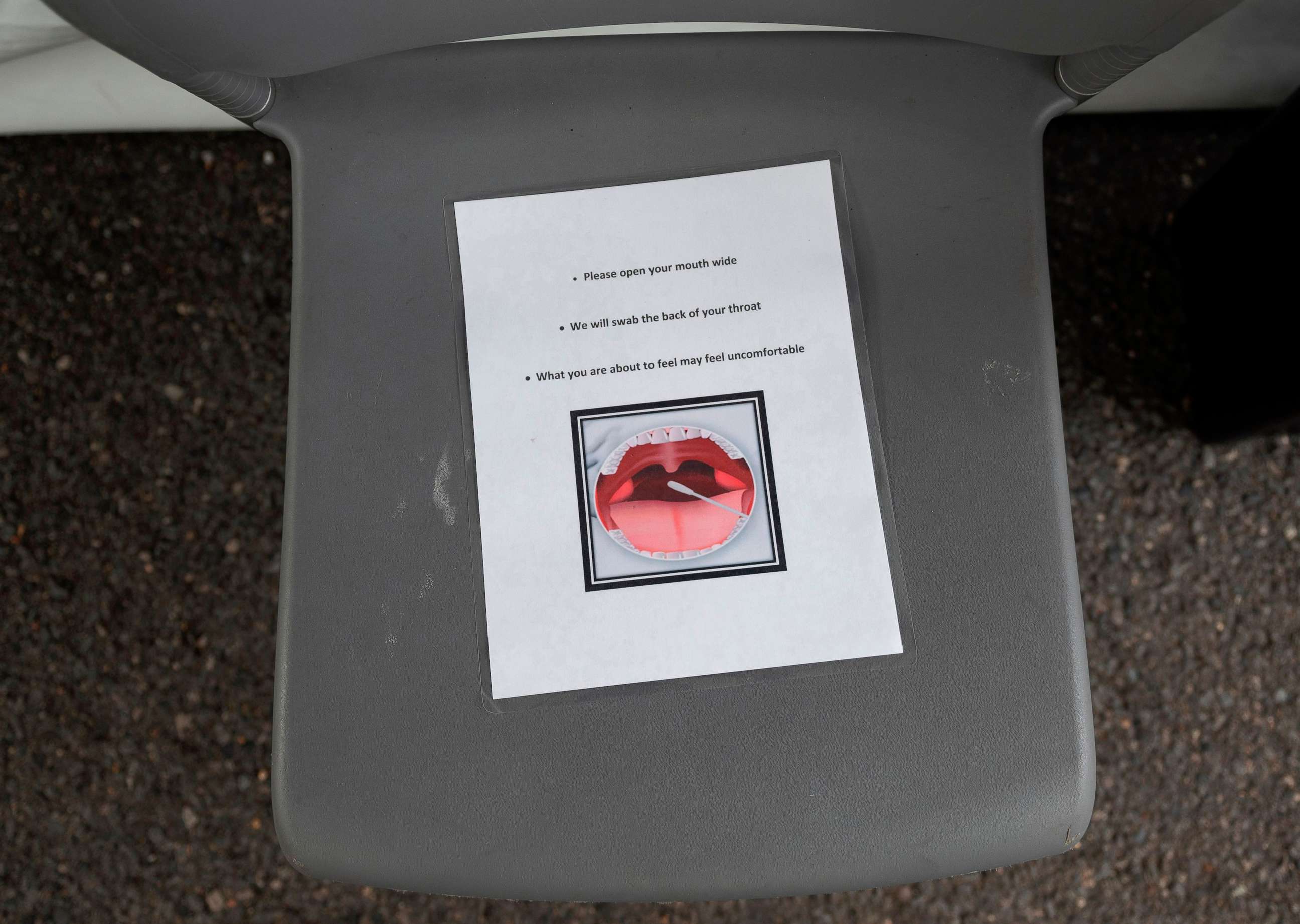 PHOTO: Instructions for being tested for coronavirus, COVID-19, are seen on a chair at a drive through testing site in Arlington, Va., on March 20, 2020.