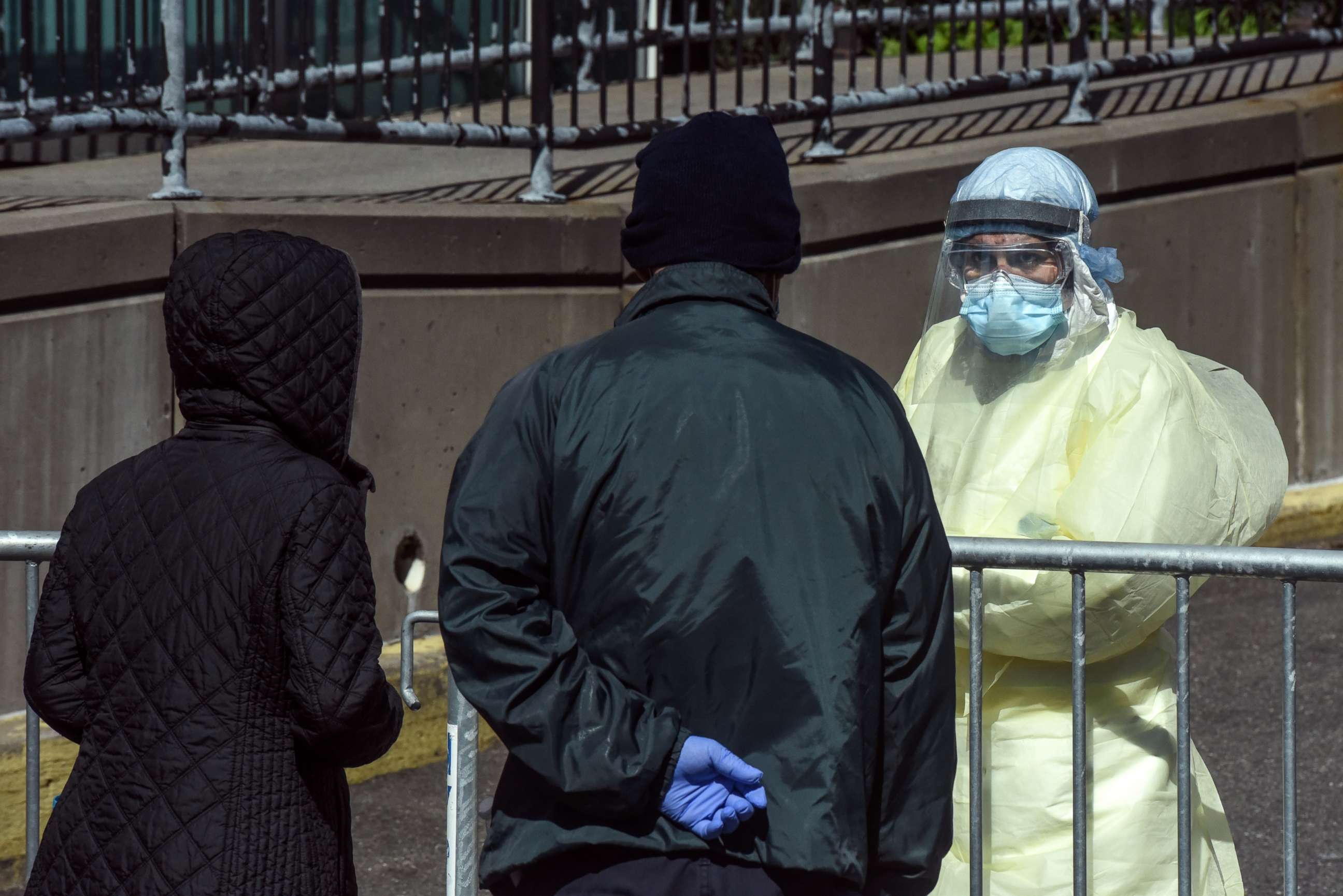 PHOTO: A medical worker speaks with people outside of Elmhurst Hospital on April 1, 2020, in New York.