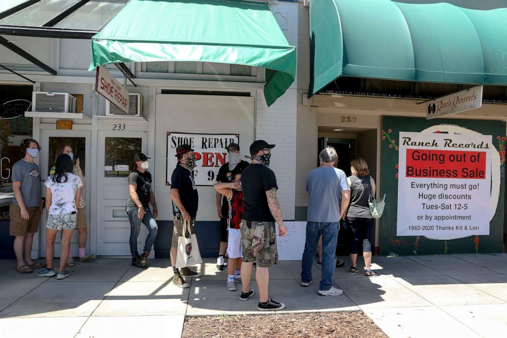 PHOTO: People line up to enter Ranch Records for the going out of business sale in Salem, Ore., June 23, 2020. The record store is closing after nearly 40 years in business.