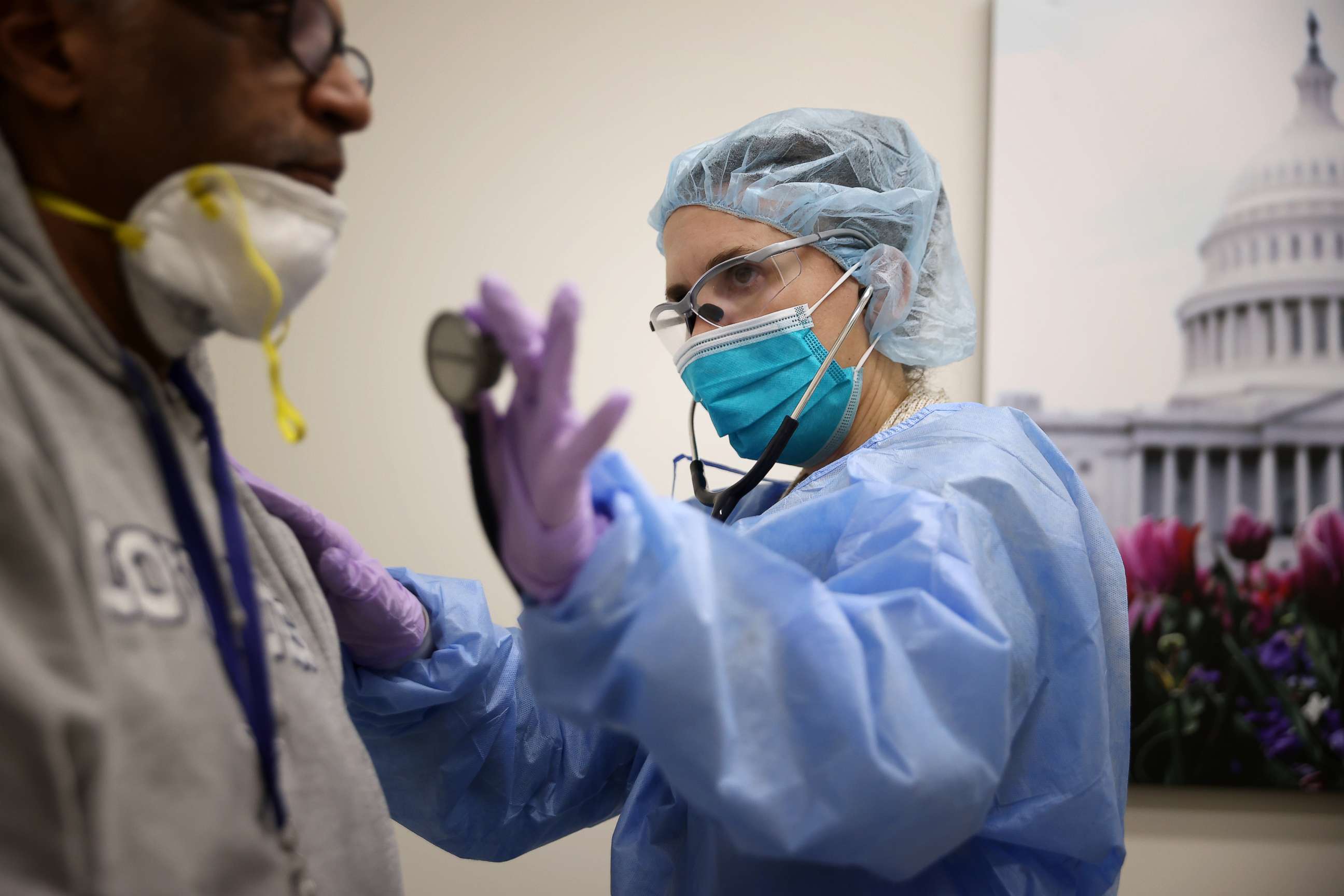 PHOTO: Nurse Practitioner Diane Alvarez examines a patient while testing him for the novel coronavirus at the Velocity Urgent Care in Woodbridge, Va., April 15, 2020.
