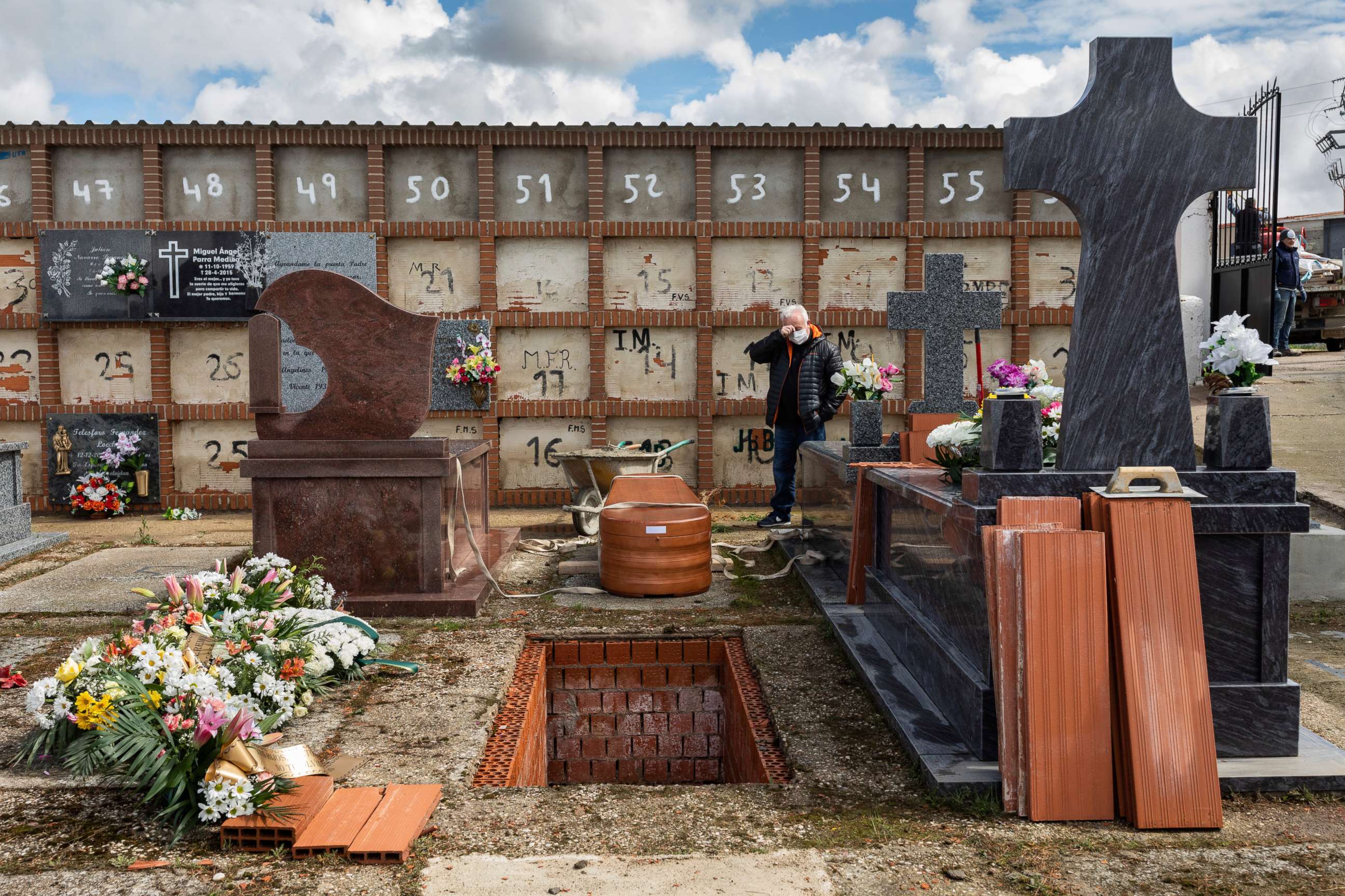 PHOTO: Julian Fernandez Mascaraque, 59, attends the burial of his mother Rosalia Mascaraque, 86, during the coronavirus outbreak in Zarza de Tajo, central Spain, Wednesday, April 1, 2020.