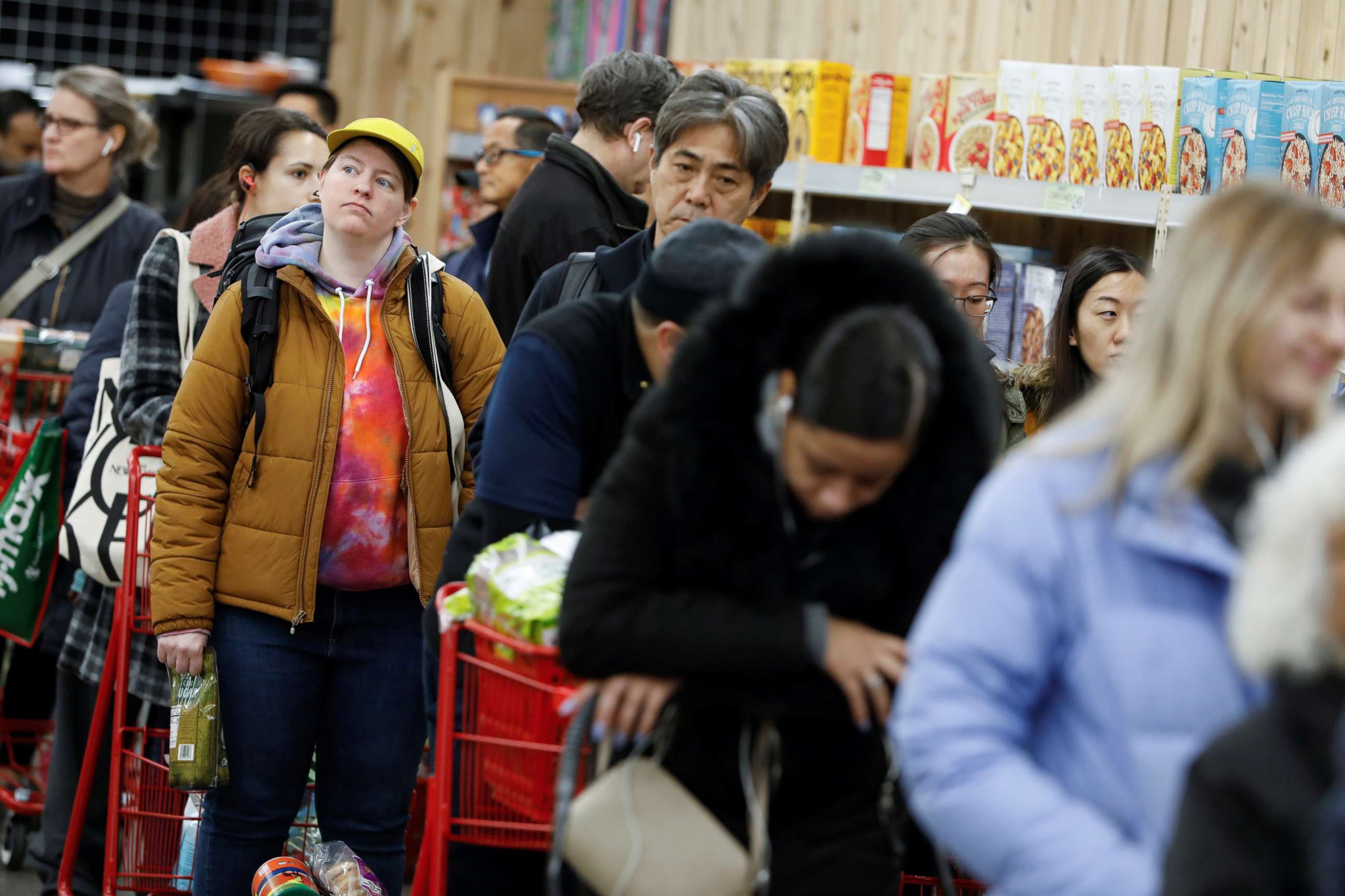 PHOTO: People line up to purchase goods at a downtown Trader Joe's as more cases of coronavirus were confirmed in the Manhattan borough of New York, March 12, 2020.