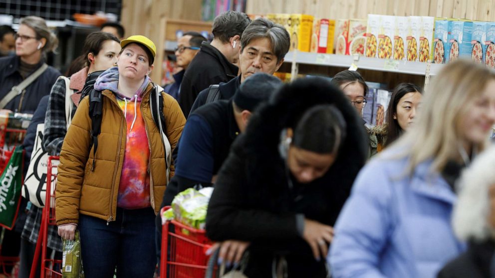 PHOTO: People line up to purchase goods at a downtown Trader Joe's as more cases of coronavirus were confirmed in the Manhattan borough of New York, March 12, 2020.