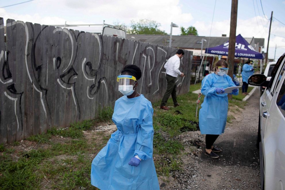 PHOTO: Staff of Odyssey House Louisiana, which runs a drive-through testing site for the coronavirus disease, work at the site in New Orleans, March 27, 2020.
