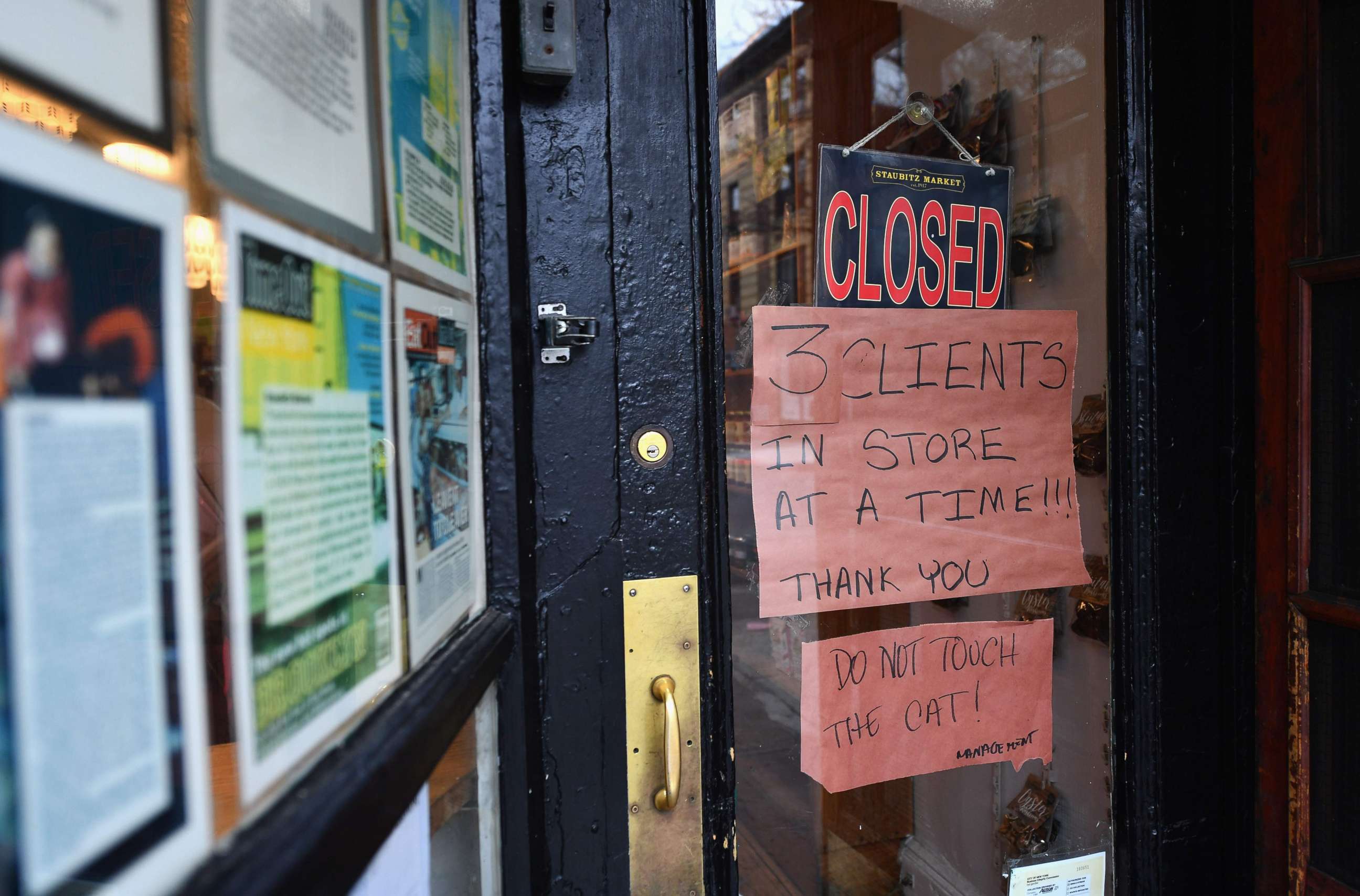 PHOTO: A sign outside a local butcher limits the number of customers in the shop, on March 20, 2020, in the Brooklyn borough of New York.