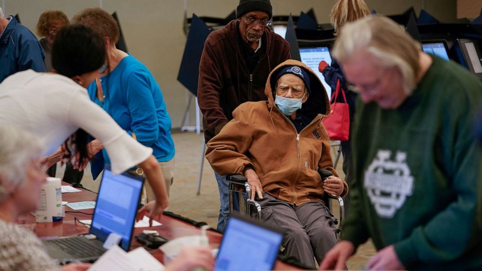 PHOTO: Robert Harrison, 96, arrives to vote while wearing a mask to prevent exposure to novel coronavirus, in Hamilton, Ohio, March 12, 2020.