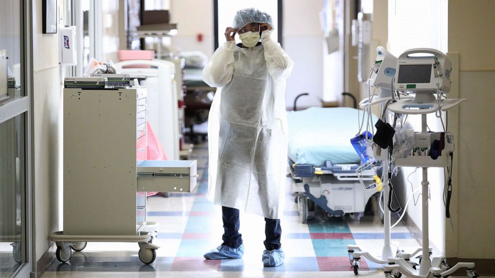 PHOTO: Nurses in the emergency department of MedStar St. Mary's Hospital don personal protective equipment before entering the room of a patient suspected of having coronavirus April 8, 2020, in Leonardtown, Md.