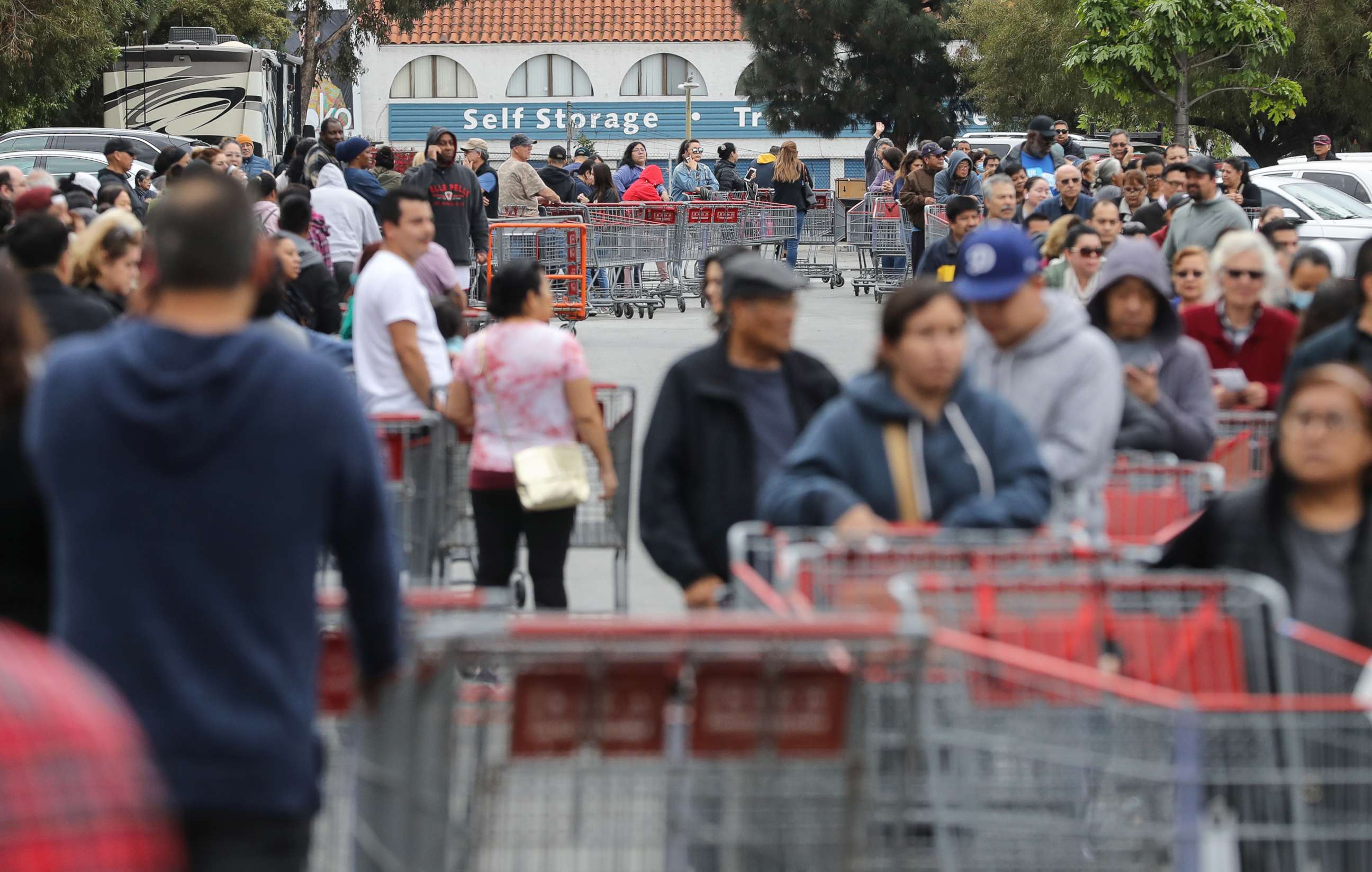 PHOTO: People wait in line to enter a Costco Wholesale store before it opens in the morning on March 12, 2020, in Glendale, Calif.