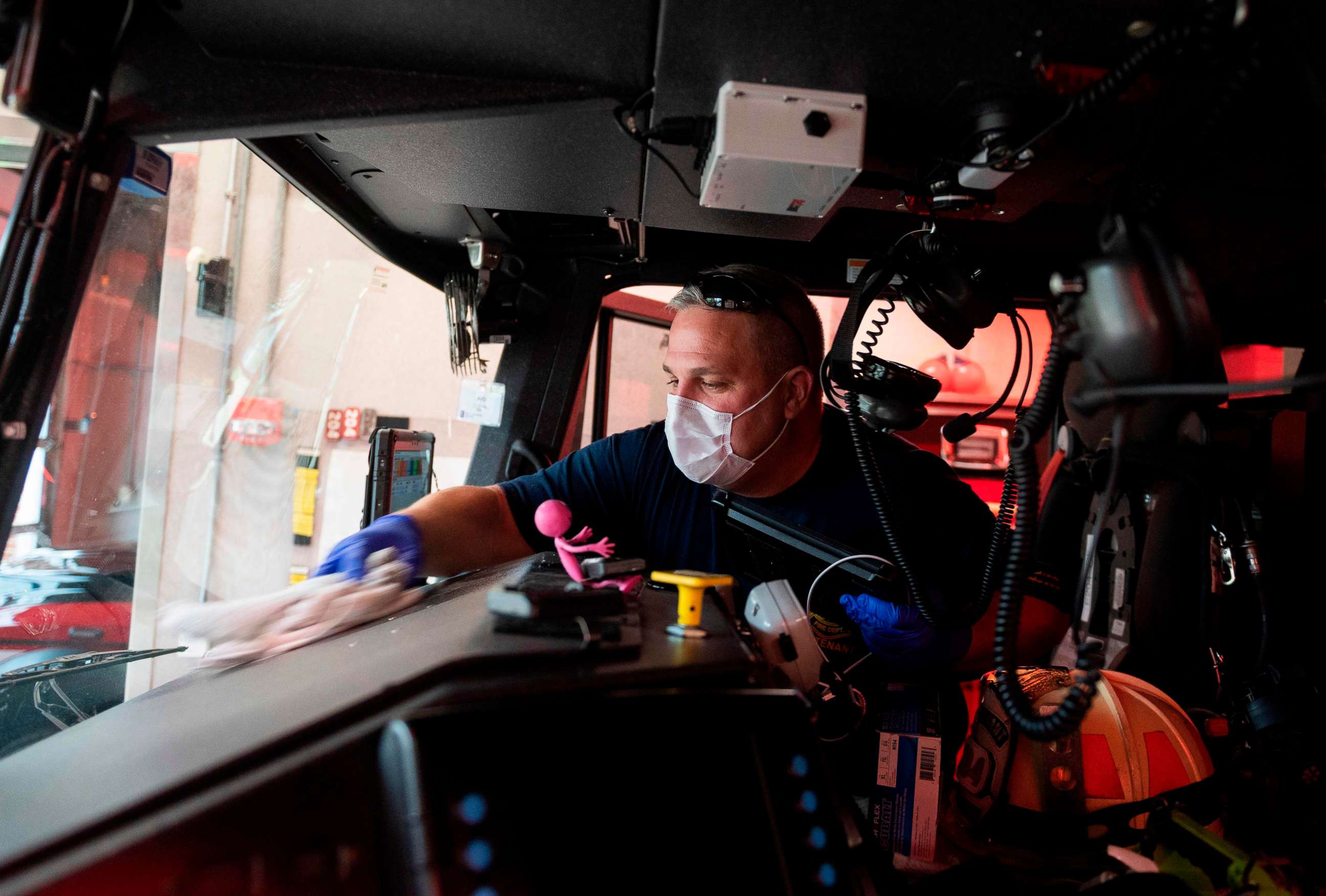 PHOTO: Lieutenant Gordon Wills cleans the fire engine with a bleach solution during the implementation of new safety measures to protect against the coronavirus, COVID-19, at Alexandria Fire Station 204 in Virginia, April 8, 2020.