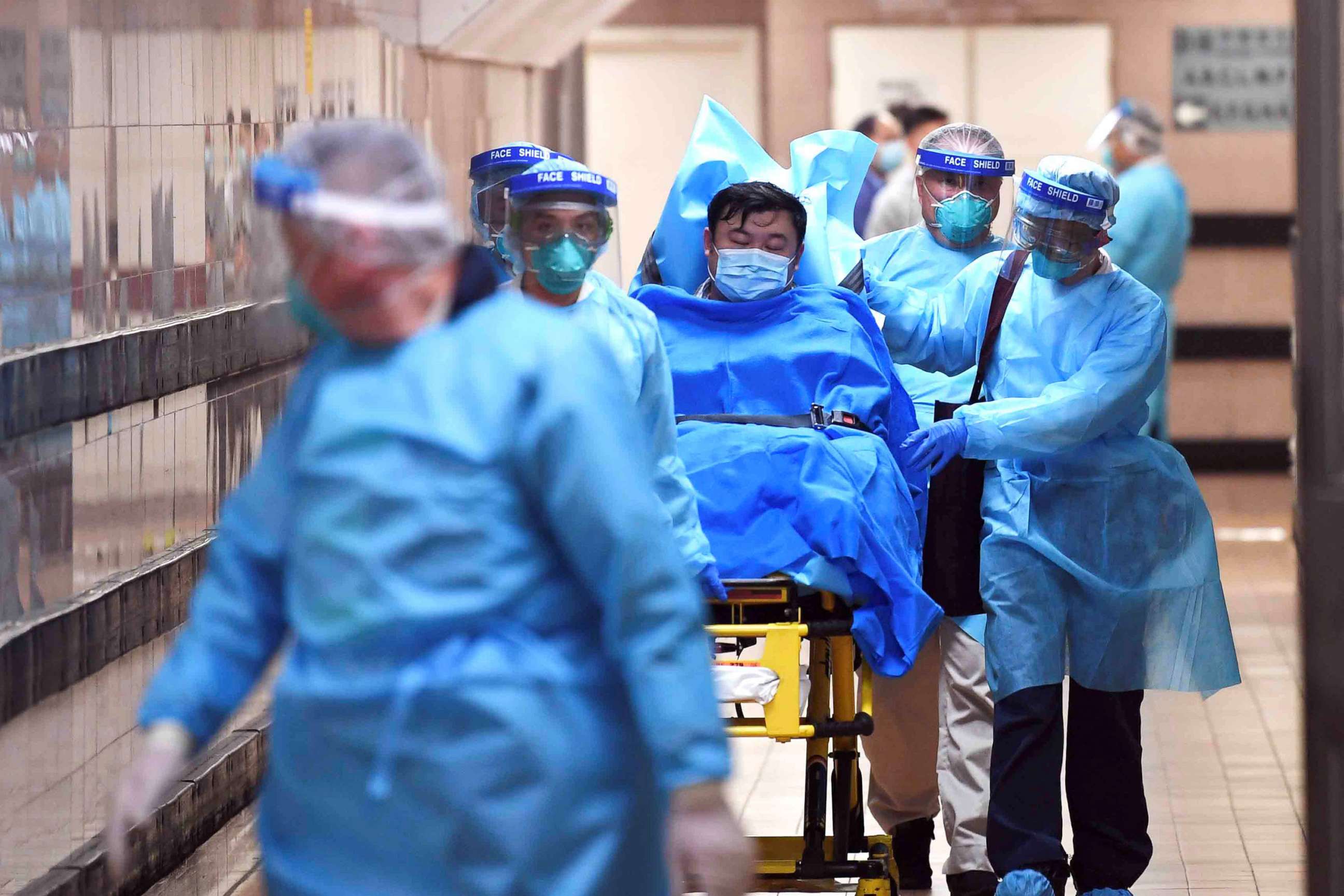 PHOTO: Medical staff transfer a patient of a highly suspected case of a new coronavirus at the Queen Elizabeth Hospital in Hong Kong, Jan. 22, 2020. 
