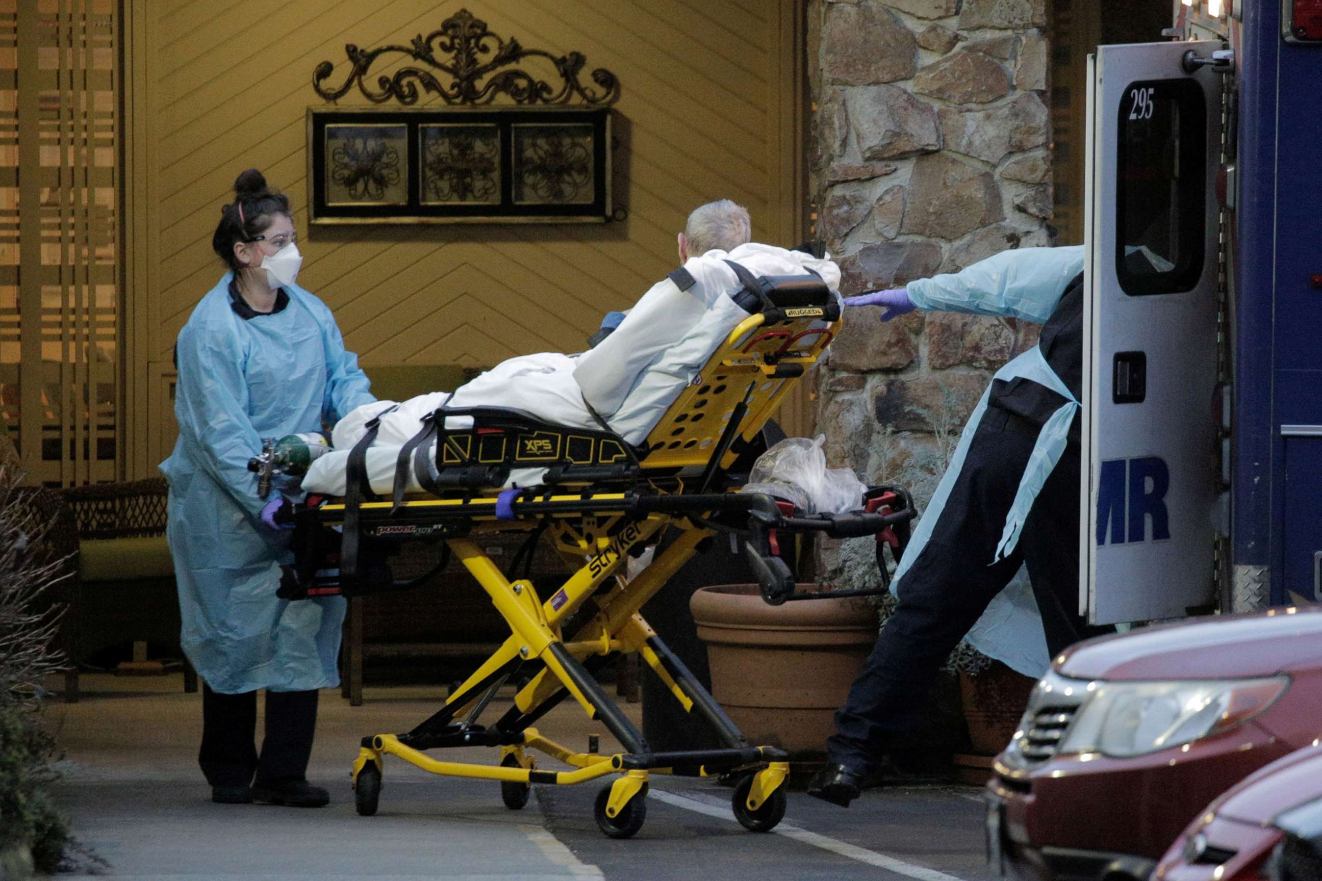 PHOTO: Medics transport a patient into an ambulance at the Life Care Center of Kirkland, the long-term care facility linked to several confirmed coronavirus cases in the state, in Kirkland, Washington, March 10, 2020. 