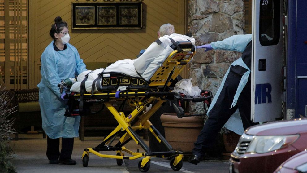 PHOTO: Medics transport a patient into an ambulance at the Life Care Center of Kirkland, the long-term care facility linked to several confirmed coronavirus cases in the state, in Kirkland, Washington, March 10, 2020. 