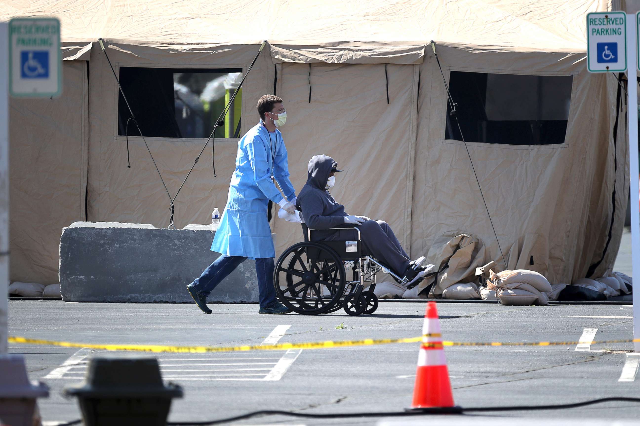 PHOTO: Healthcare professionals screen people for the coronavirus at a testing site organized by the Maryland National Guard in a parking lot at FedEx Field, March 30, 2020, in Landover, Md. 