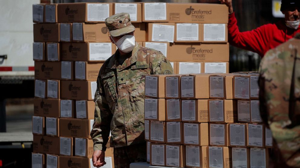 PHOTO: U.S. Army National Guard personnel distribute boxes of free meals to residents in the East Harlem section of Manhattan during the outbreak of the coronavirus disease in New York, April 1, 2020.