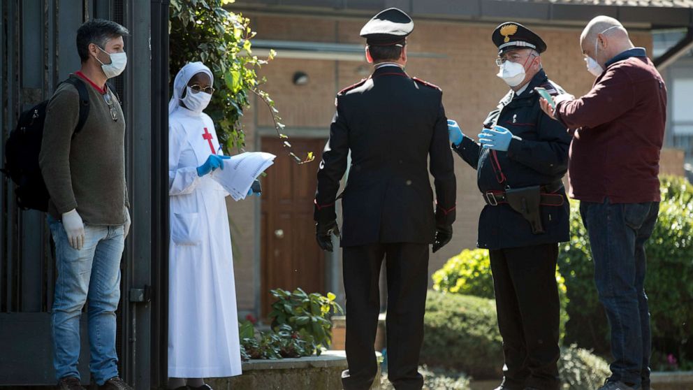 PHOTO: Carabinieri officers talk to a nun at the Institute of Daughters of St. Camillo in Grottaferrata, near Rome, March 20, 2020.