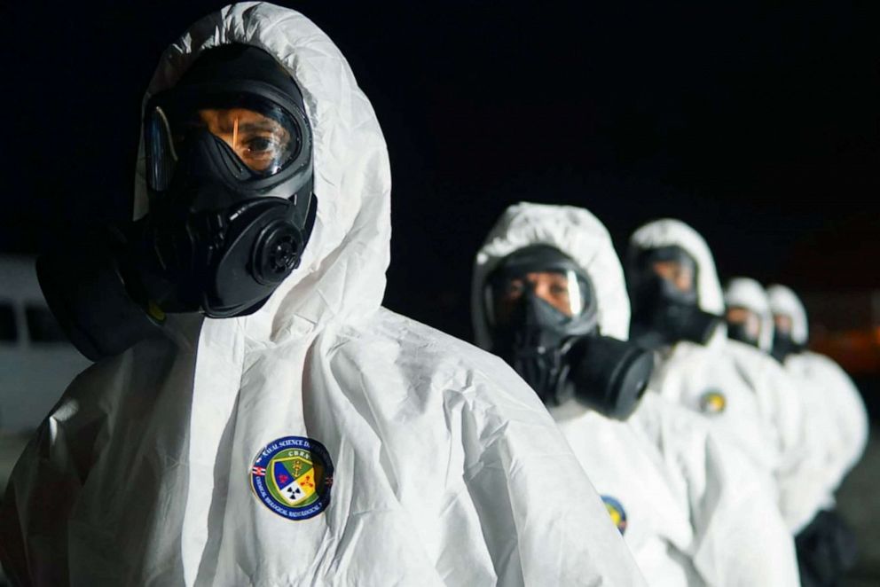 PHOTO: Royal Thai Navy officials prepare for the arrival of a plane carrying Thai nationals who had been evacuated from Wuhan, China, the epicentre of the coronavirus outbreak, Feb. 4, 2020, in Rayong, Thailand. 