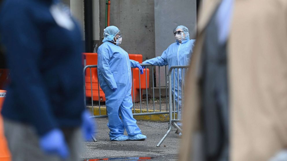 PHOTO: Medical staff talks outside a COVID-19 screening tent at the Brooklyn Hospital Center on March 20, 2020, in the Brooklyn borough of New York.