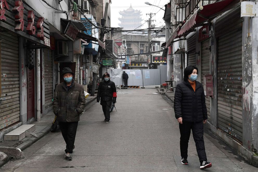PHOTO: People wearing masks walk in Wuhan, China Feb. 27, 2020.