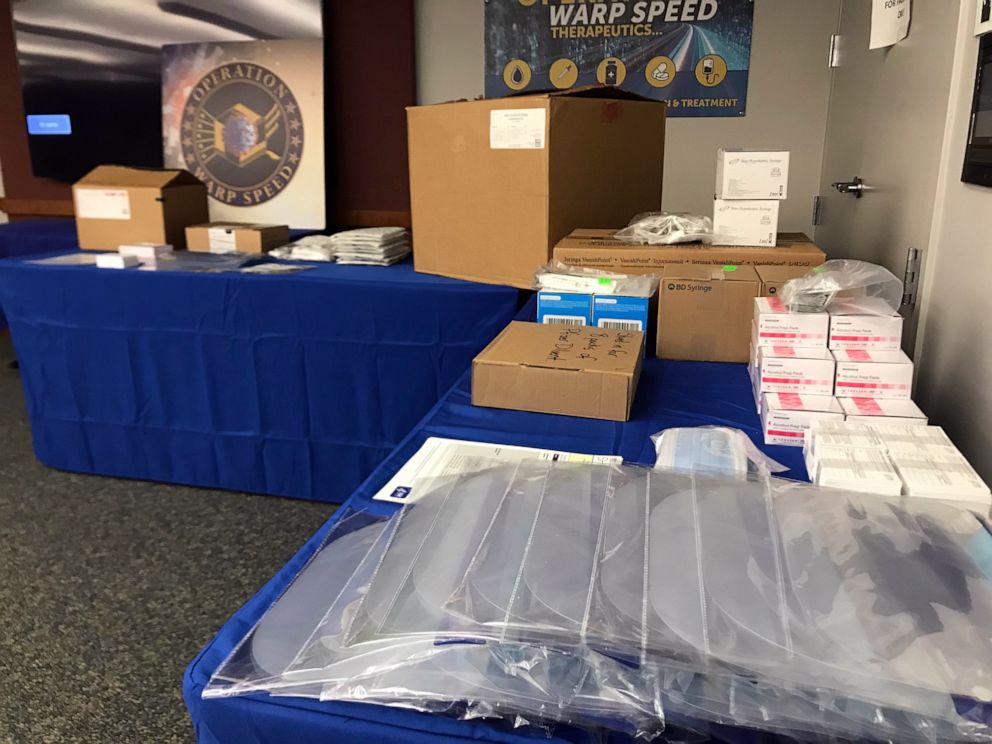 PHOTO: Ancillary kits containing needles, syringes, face screens, masks, and other materials that will be sent with the Pfizer and Moderna coronavirus vaccines to administration sites are displayed at Operation Warp Speed headquarters.