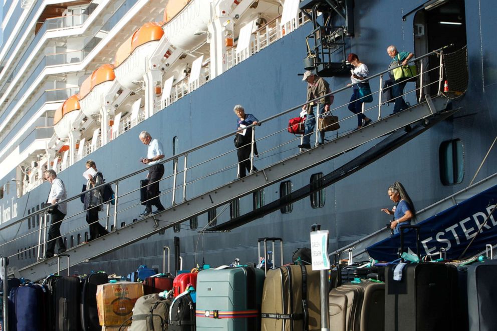 PHOTO: Passengers of the MS Westerdam, back, owned by Holland America Line, disembark at the port of Sihanoukville, Cambodia, Feb. 15, 2020.