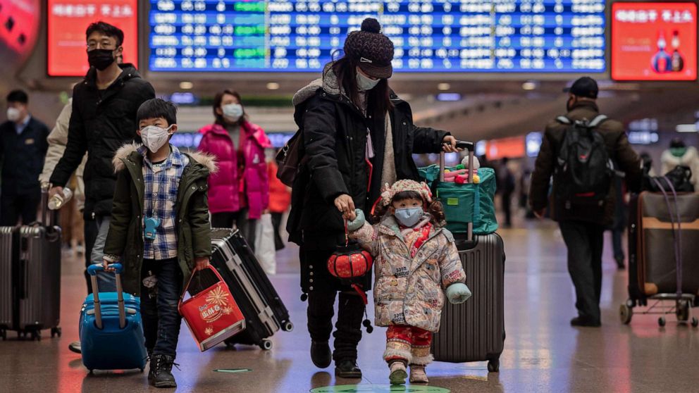 PHOTO: Travelers wear face masks at Beijing West Railway Station in Beijing, Jan. 24, 2020.