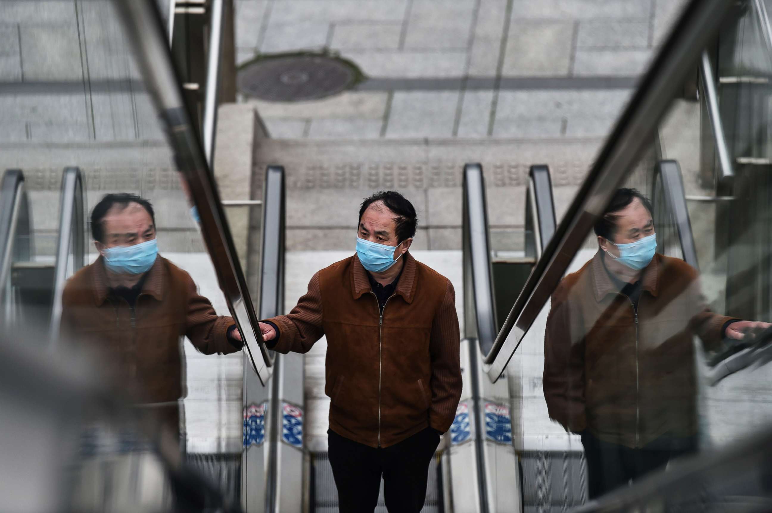 PHOTO: A man wearing a face mask uses an escalator in the financial district of Lujiazui in Shanghai, March 4, 2020.