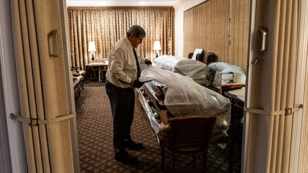 PHOTO: Funeral Director Joe Neufeld inventories the bodies of coronavirus victims bound for burial, in the main chapel of the Gerard J. Neufeld Funeral Home in Queens, New York, April 26, 2020.