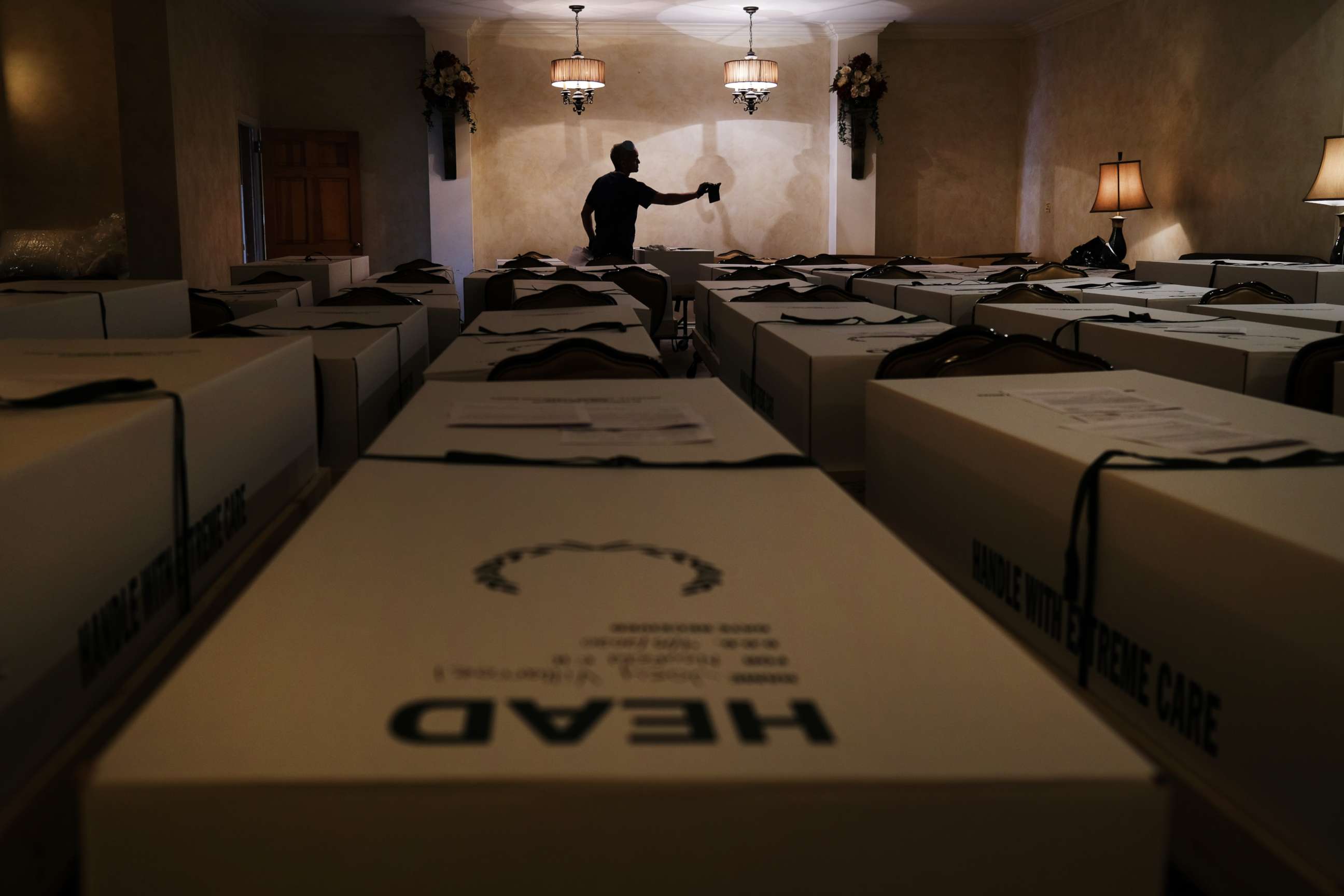 PHOTO: A worker organizes bodies in the Gerard Neufeld funeral home in Queens on April 22, 2020, in New York.